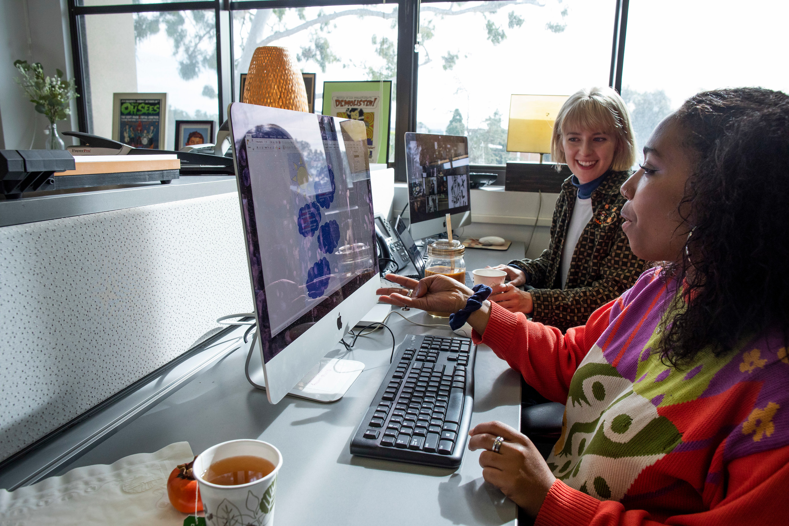 two women collaborating on computer